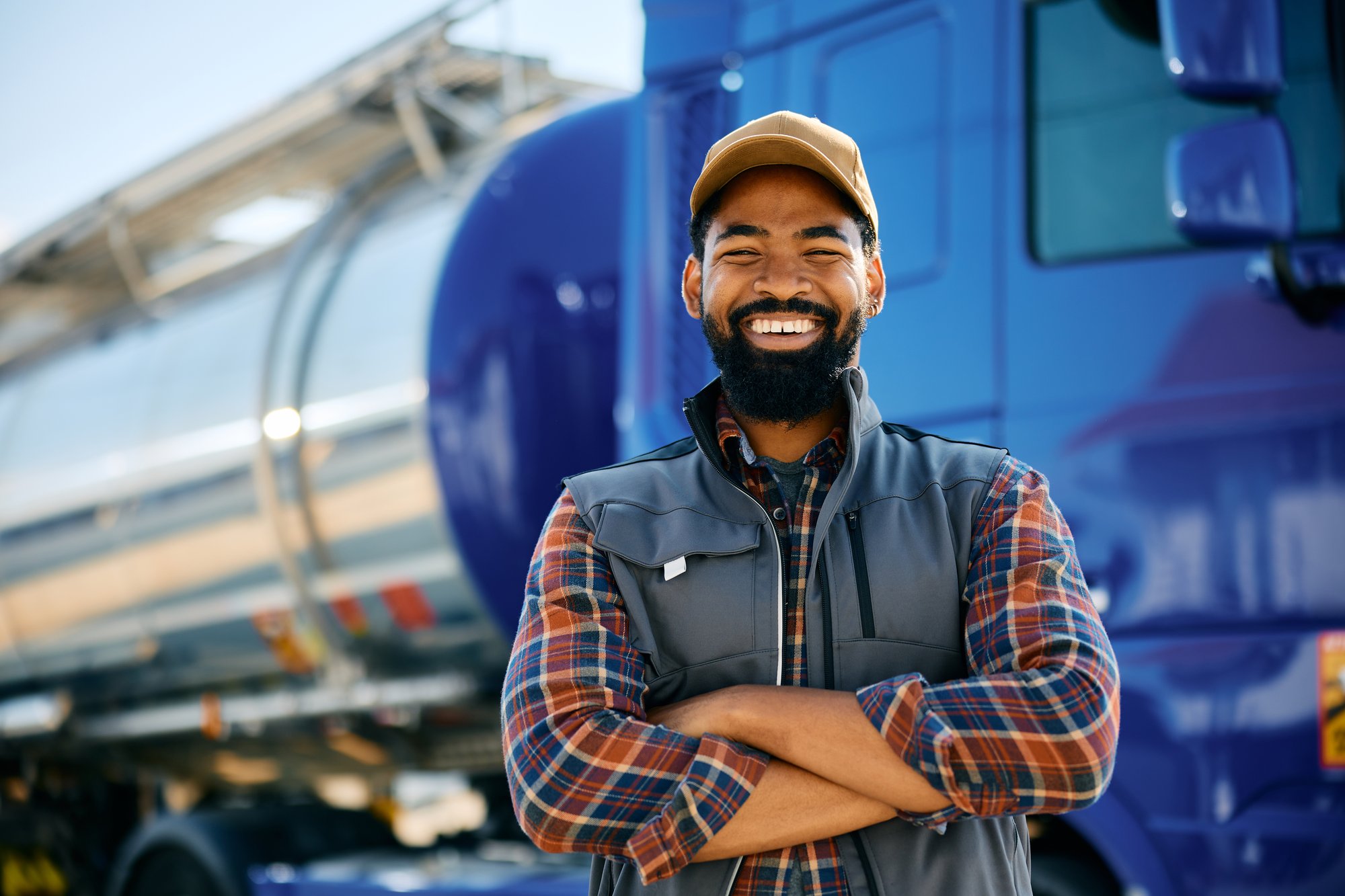 happy-black-truck-driver-with-arms-crossed-looking-2024-12-13-18-36-25-utc