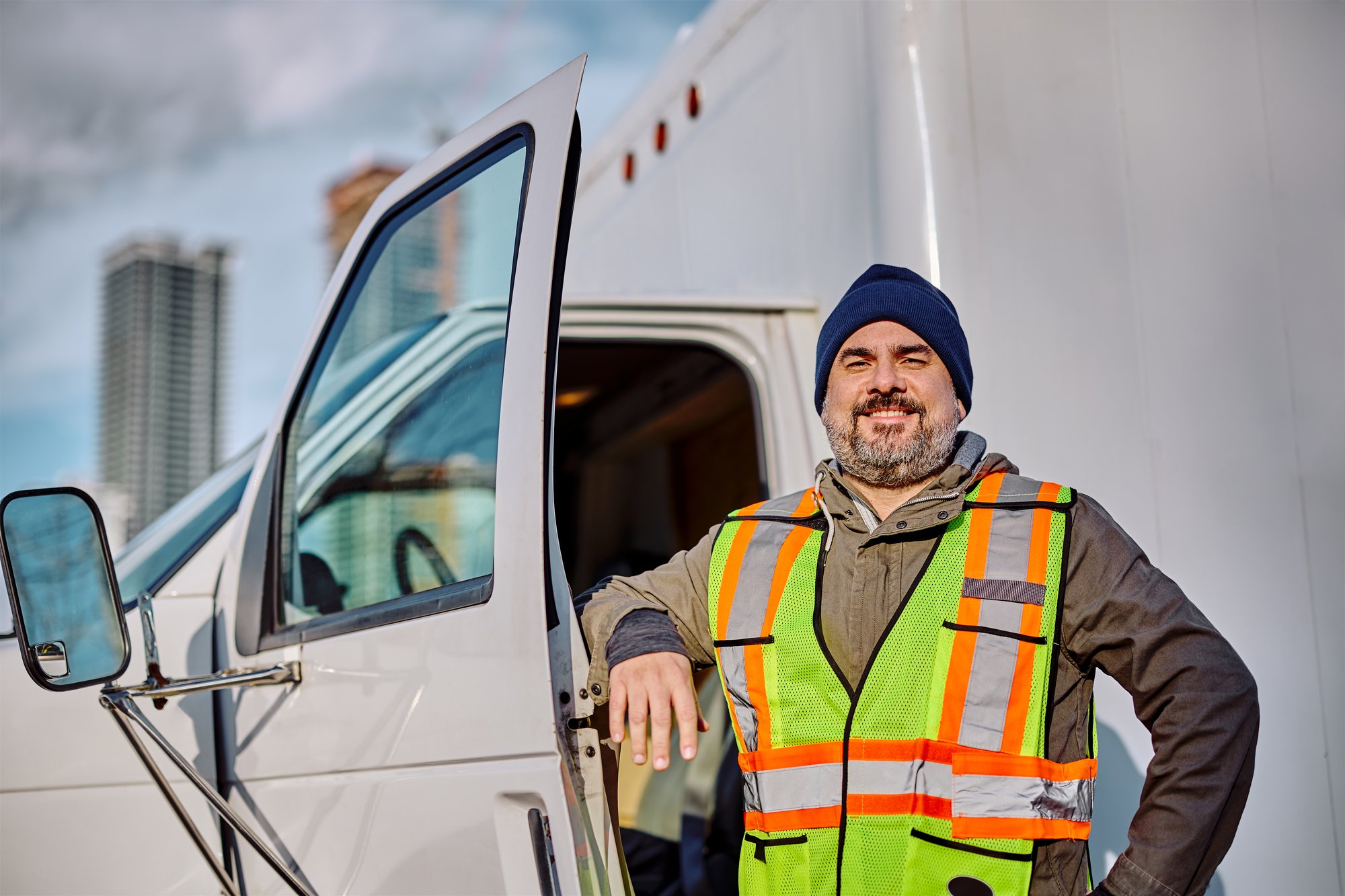 happy-professional-truck-driver-looking-at-camera-2024-12-13-18-19-46-utc